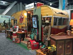 an exhibit room filled with lots of different types of furniture and decor on the walls