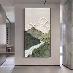 a large painting hanging on the wall in a living room next to a door way