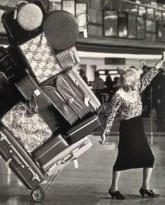 an old photo of a woman with luggage on her back at the airport in black and white