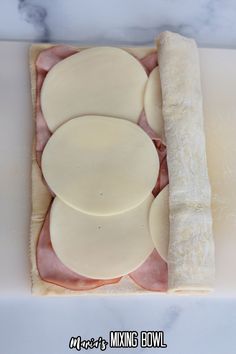 an uncooked ham and cheese sandwich on a roll