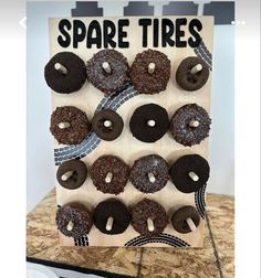 a wooden sign with chocolate donuts on it and the words spare tires above them