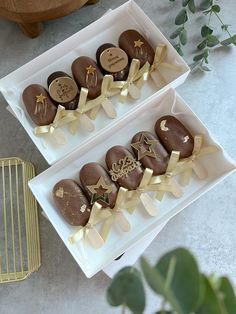 two boxes filled with chocolates sitting on top of a table