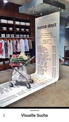 a shopping cart sitting on top of a table in front of a store display case