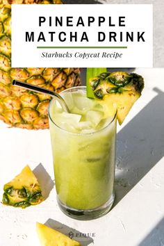 a pineapple matcha drink in a glass next to some sliced pineapples