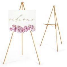 an easel with flowers on it and a welcome sign