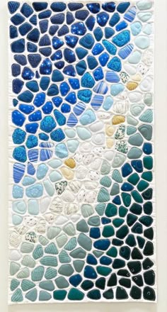 a piece of art made out of blue and white rocks