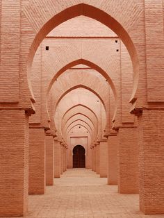 an archway in the middle of a building with brick walls and arches on either side