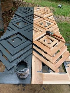 some wood is laying on the ground next to a paint can