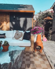 a white couch sitting on top of a wooden patio