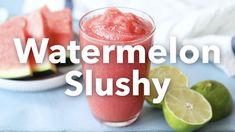 watermelon slushy in a glass next to sliced limes