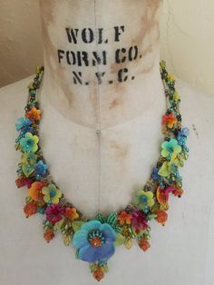 Dripping with colorful hand-painted flowers and glass beads, what a perfect necklace to make you feel like your on a holiday in Havana. This necklace has multi colored flowers of turquoise, yellow, orange and red. A unique and bright fun color combo.It measures almost 20 inches with a 4 inch extender so as you may adjust the length as needed. We use findings that are nickel free. This is a hand beaded piece of jewelry. All the work is hand sewn or wired without the use of glue. This heirloom qua Whimsical Multicolor Beaded Necklaces, Adjustable Multicolor Flower Necklace With Flower Charm, Multicolor Bohemian Flower Necklace For Crafts, Multicolor Bohemian Flower Necklace For Jewelry Making, Multicolor Hand Painted Bohemian Beaded Necklace, Bohemian Multicolor Flower Necklace For Jewelry Making, Multicolor Hand Painted Beaded Bohemian Necklace, Bohemian Multicolor Adjustable Flower Necklace, Bohemian Multicolor Hand Painted Beaded Necklaces