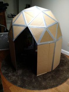 the inside of a cardboard structure on top of a rug