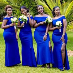 four women in blue dresses posing for the camera