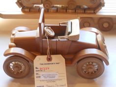 a wooden toy car with a price tag attached to it