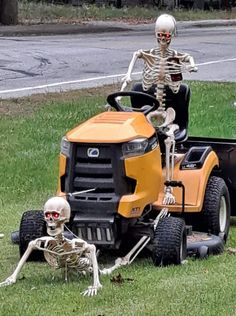 two skeletons are riding on a lawn mower