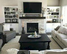 a living room filled with furniture and a flat screen tv mounted above the fire place