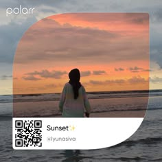 a woman standing on top of a beach next to the ocean under a cloudy sky