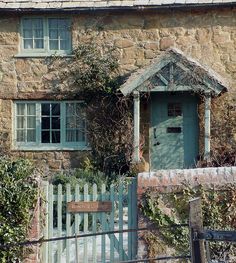 an old stone house with a green door