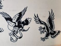 three black and white drawings of birds on a wall