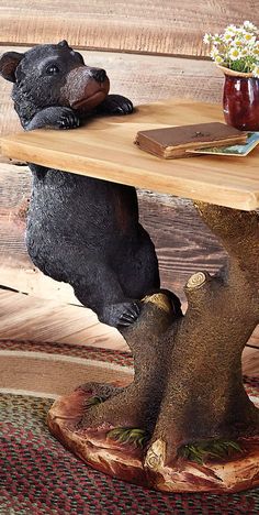 a bear statue sitting on top of a wooden table