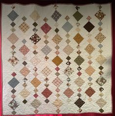 a large quilt is hanging on the wall