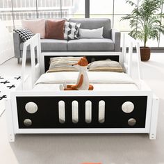 a modern day bed with an animal toy in the middle