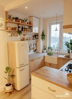 a white refrigerator freezer sitting inside of a kitchen next to a sink and stove