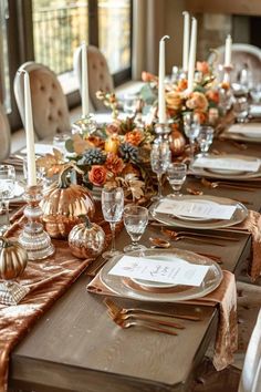 a table set with place settings and candles