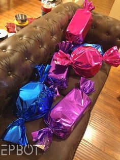 the couch is covered in many different colored wrappers