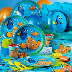 an image of a birthday party set up with balloons and fish on the tablecloth