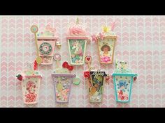 there are many little cupcakes hanging on the wall with different designs and colors