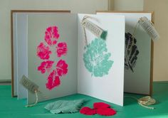 two greeting cards with leaves on them, one is green and the other is pink