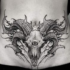 a black and white photo of a woman's stomach with dragon tattoos on it