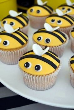 cupcakes with yellow frosting decorated like bees