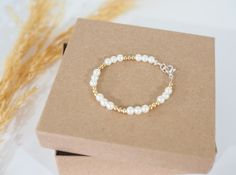 "This 14k gold filled pearl baby bracelet is adorable! This bracelet is great for baby showers, birthdays, baptisms, etc. The bracelet is lightweight, and easy to wear. Girls sizing also available.  The sizes that are available are:  3.5\" (newborn) 4.0\" (ages 1-3),  4.5\", 5.0\" (ages 4-10) Need a custom size? Message me for the right size! All of my bracelets are available for custom sizing.  These are great for group gifts, bridal parties, sports teams, holiday gifts, birthdays, and so much more! If you need to order more than 10, please message me! I would love to make a wholesale order for you!" Gold Pearl Jewelry For Baptism, White Dainty Pearl Bracelet For Birthday, Gold Pearl Jewelry For Birthdays, Dainty White Pearl Bracelet For Birthday, Gold Pearl Jewelry For Birthday, Hypoallergenic Gold Pearl Bracelet As Gift, Gold Beaded Birthstone Bracelets For Birthday, Gold Pearl Bracelet For Mother's Day Anniversary, Gold Bracelet With Pearl Charm For Gift