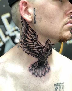 a man with a bird tattoo on his neck