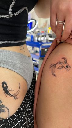 two women with tattoos on their butts