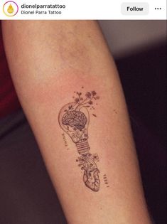 a tattoo on the arm of a woman with a light bulb and flowers in it