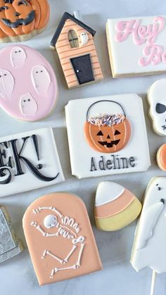 decorated cookies are arranged in the shape of houses and jack - o'- lanterns