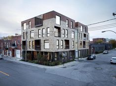 an apartment building with many windows and balconies on the top floor is shown