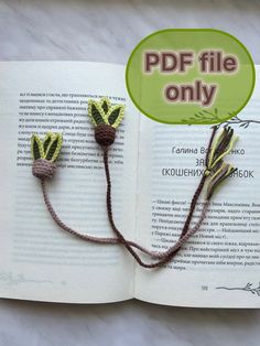 an open book with two crocheted flowers on it