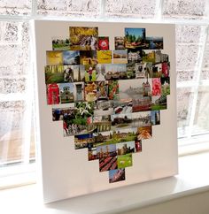 a heart made out of photos hanging on a window sill