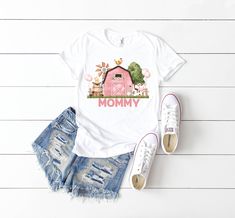 a t - shirt with the words mommy on it next to ripped shorts and sneakers