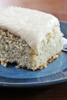 a piece of cake with white frosting on a blue plate