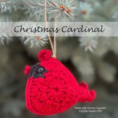 a crocheted christmas ornament hanging from a tree with the words christmas cardinal on it