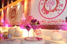 a room with white couches and pink decorations