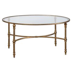 an oval glass table with gold metal legs