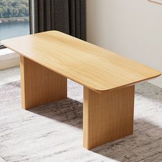 a wooden table sitting on top of a carpeted floor next to a large window