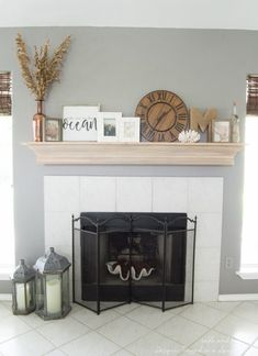 a living room with a fire place and some decorations on the mantel above it