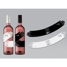 three bottles of wine with black and white labels next to each other on a gray background